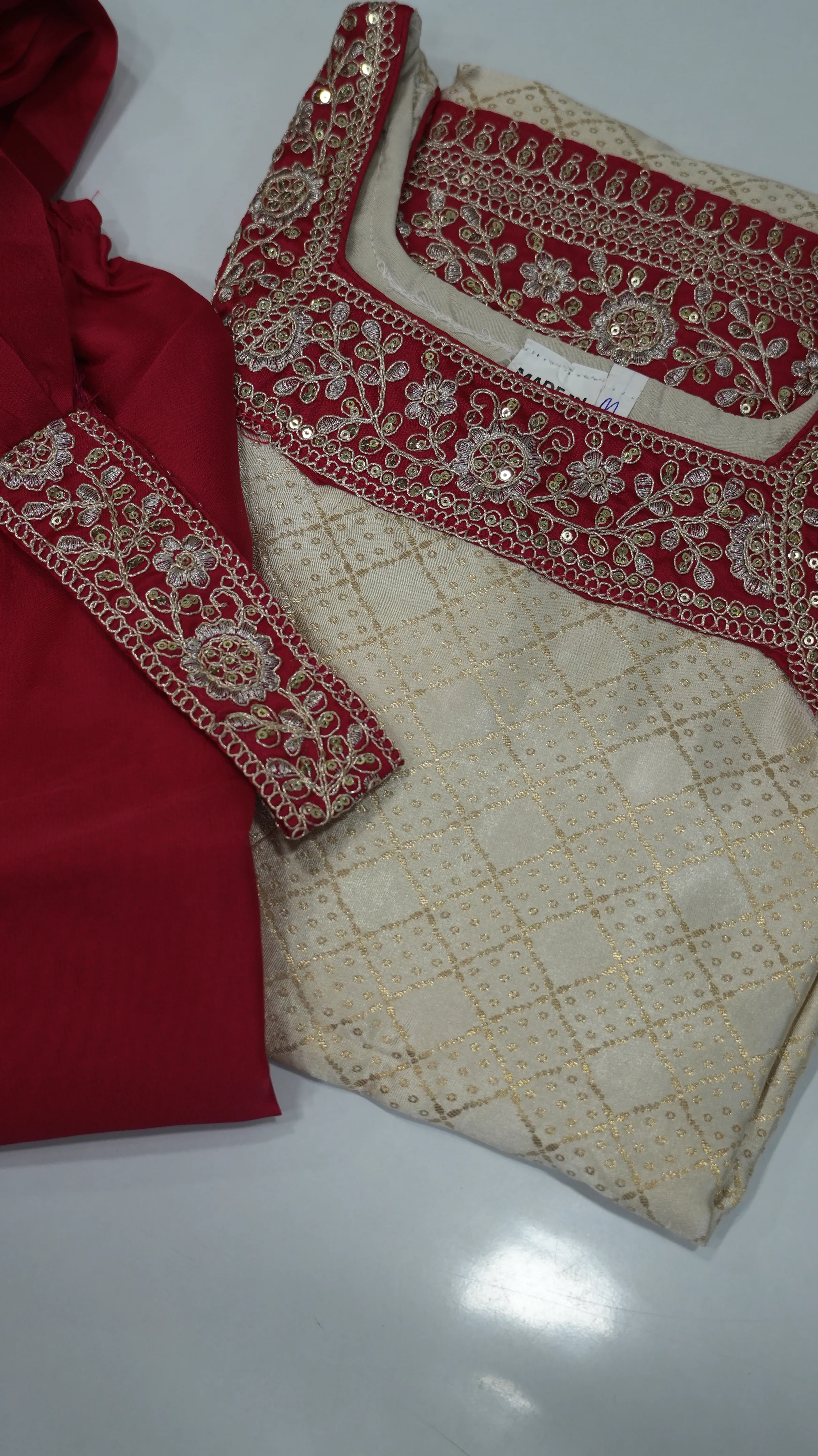 The full chudidhar set — brocade kurta with matching crimson bottom piece
