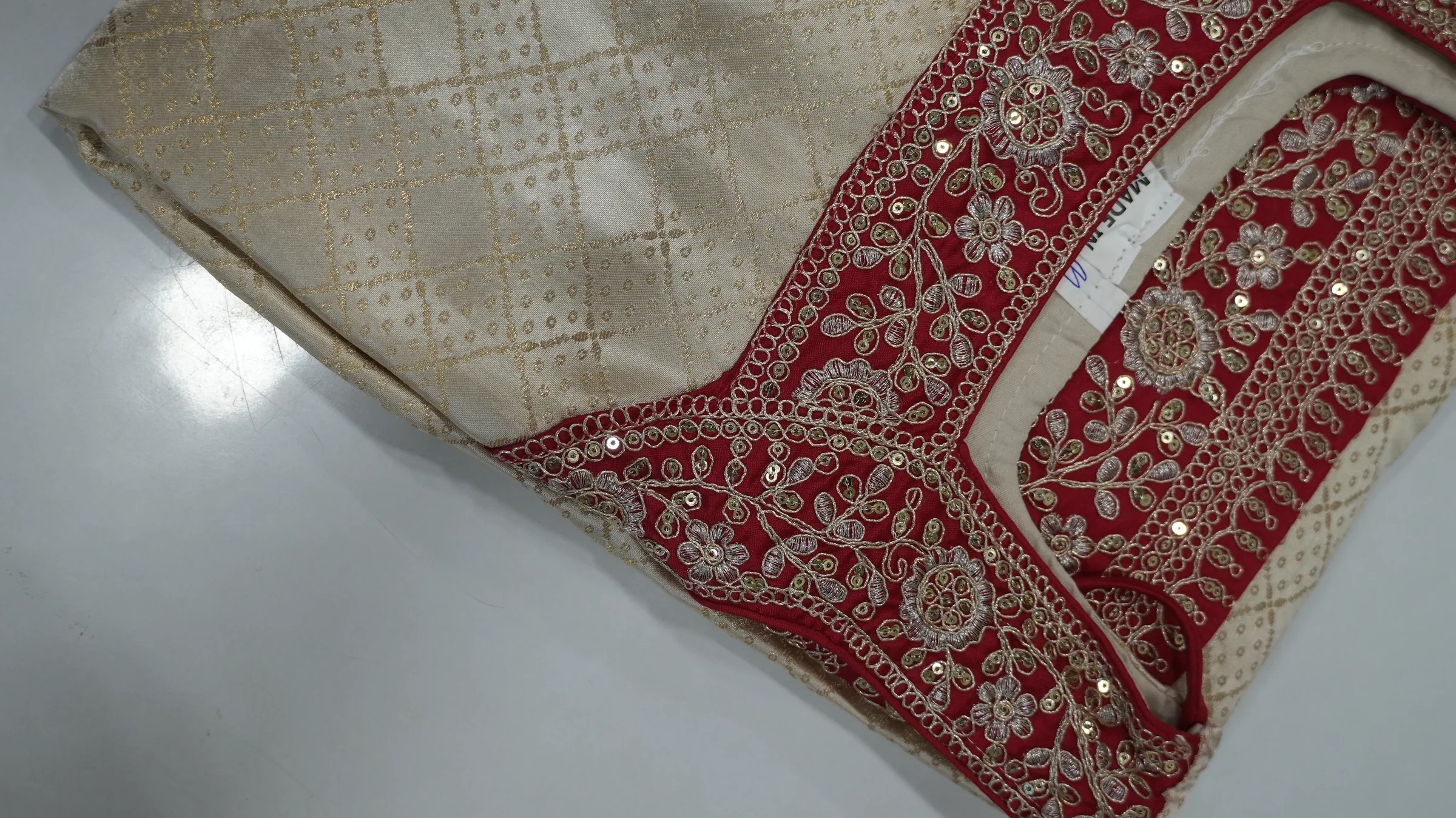 Cream gold-brocade kurta with crimson zari-embroidered yoke